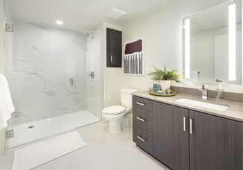 Hand-set tile showers with glass enclosures